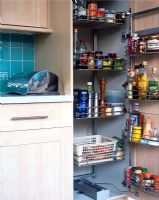 Modern kitchen open cupboard showing food storage solutions