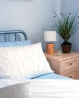 Detail double bed in bedroom and bedside cabinets
