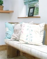 Detail of assorted patterned cushions on bench 