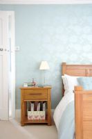 Classic bedroom with double bed and bedside table 