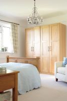 Classic bedroom with double bed, chandelier and double wardrobes