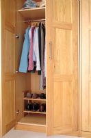 Open wardrobe showing storage for clothes