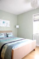 Modern bedroom with double bed and grey painted walls