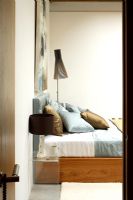 View to modern contemporary bedroom with Seppo Koho lamp