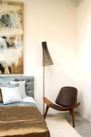 Modern contemporary bedroom with Seppo Koho lamp and shell chair