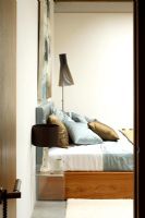 View to modern contemporary bedroom with Seppo Koho lamp