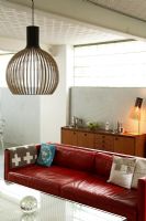 View to modern contemporary living room with Seppo Koho pendant light and lamp