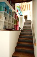 View up modern staircase with wooden stairs and storage shelves