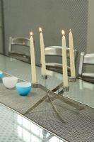 Detail of candles in candelabra on dining table