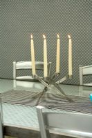Detail of candles in candelabra on dining table