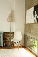 Living room with chair, Seppo Koho lamp  and exposed brick wall