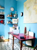 Quirky kitchen diner with blue painted walls and dining table and chairs