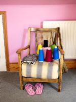 Upholstered chair with assorted reels of cotton