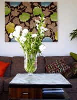 Detail of flowers in vase on coffee table in living room