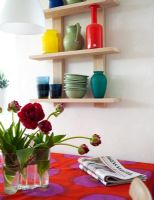Detail of modern dining room with brightly coloured tablecloth 