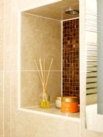 Detail of tiled bathroom shelf with accessories