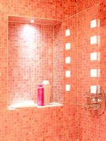 Modern shower enclosure with pink mosaic tiles