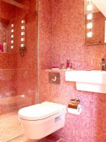 Modern bathroom with pink mosaic tiled walls 