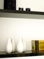 Detail of vases and candle holders on shelves