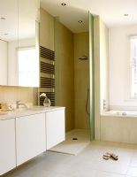 Modern white bathroom with separate bath and shower enclosure