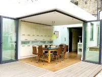 Contemporary kitchen with patio doors open to garden