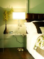 Modern bedroom with bed and bedside table and lamp 