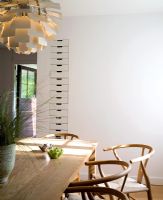 Modern dining room with Hans Wegner Y chairs and Poul Henningsen Artichoke pendant