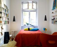 Bedrooms with bold orange bedspread and cushions