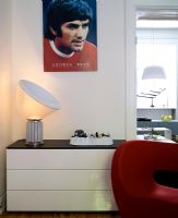 White set of drawers with Ron Arad red chair and George Best poster