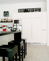 Modern white kitchen with black accessories