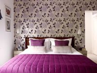 Modern bedroom with wallpapered feature wall