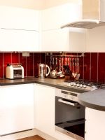 Detail of modern kitchen with white units 