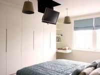 Modern bedroom with concealed television 