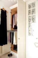 Open bedroom wardrobe showing storage 