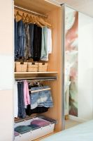 Open wardrobes showing storage space in bedroom 