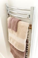 Detail of towel radiator in bathroom 