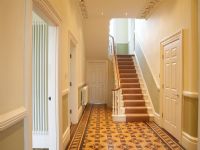 Hallway with patterned tiled floor