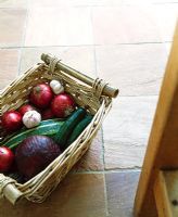 Detail of vegetable basket on stone tiled floor 