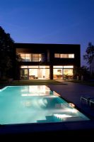 Modern house exterior with pool at night 