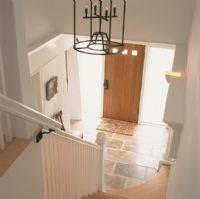 View of staircase and hallway with front door