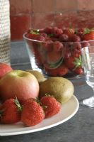 Fruits in plate and bowl of strawberries