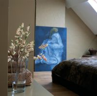 Modern bedroom with painting on wall