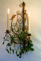 Ornate wall mounted candle holder with mistletoe