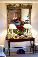 Living room with table and mirror with poinsettia