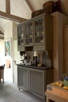 View of kitchen with crockery in cupboard