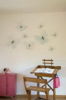 Wooden desk and chair with butterflies on wall