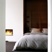 Modern bedroom with bed and fireplace