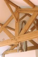 Wooden beams and steel chimney in ceiling