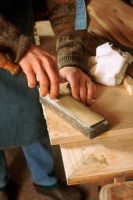 Carpenter sharpening chisel