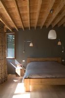 Bedroom with bed and wooden ceiling